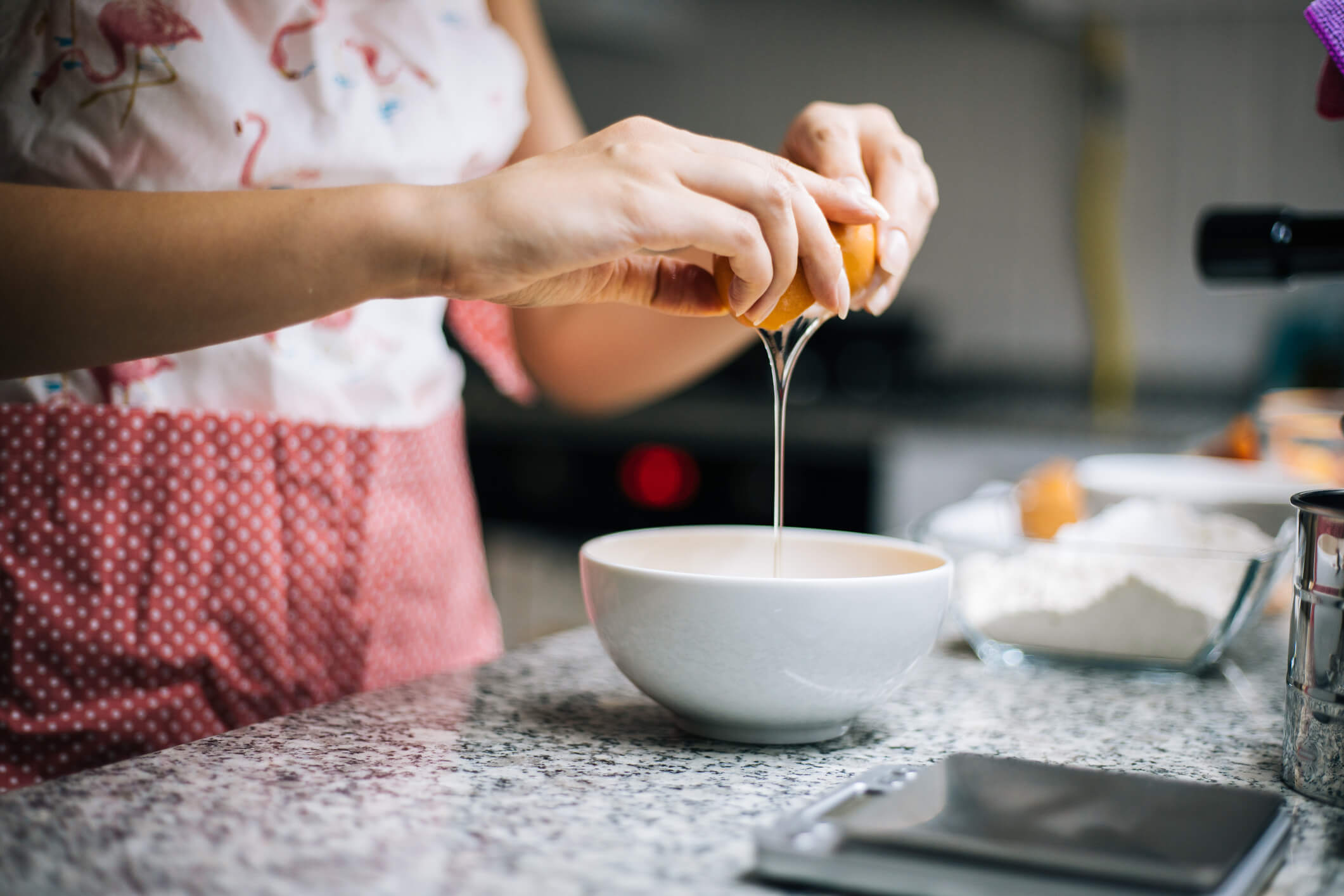 Woman cracking an egg in a bowl