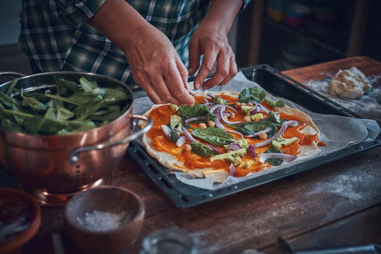 preparing vegan pumpkin pizza