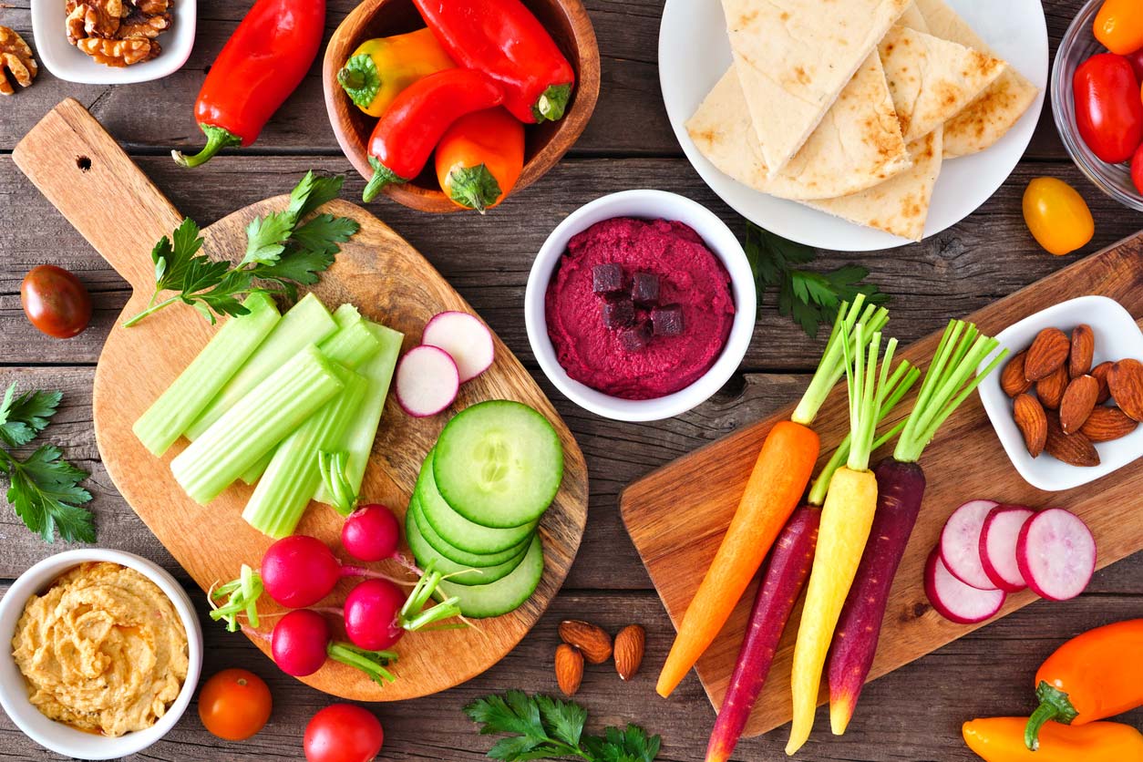 table scene with variety of cut veggies and dips