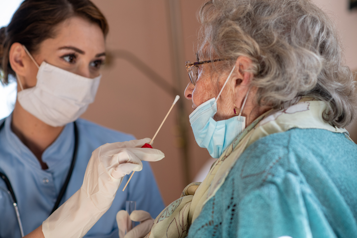 Close-up of woman getting PCR test at home during COVID-19 epidemic. Senior woman is tested during home visit.