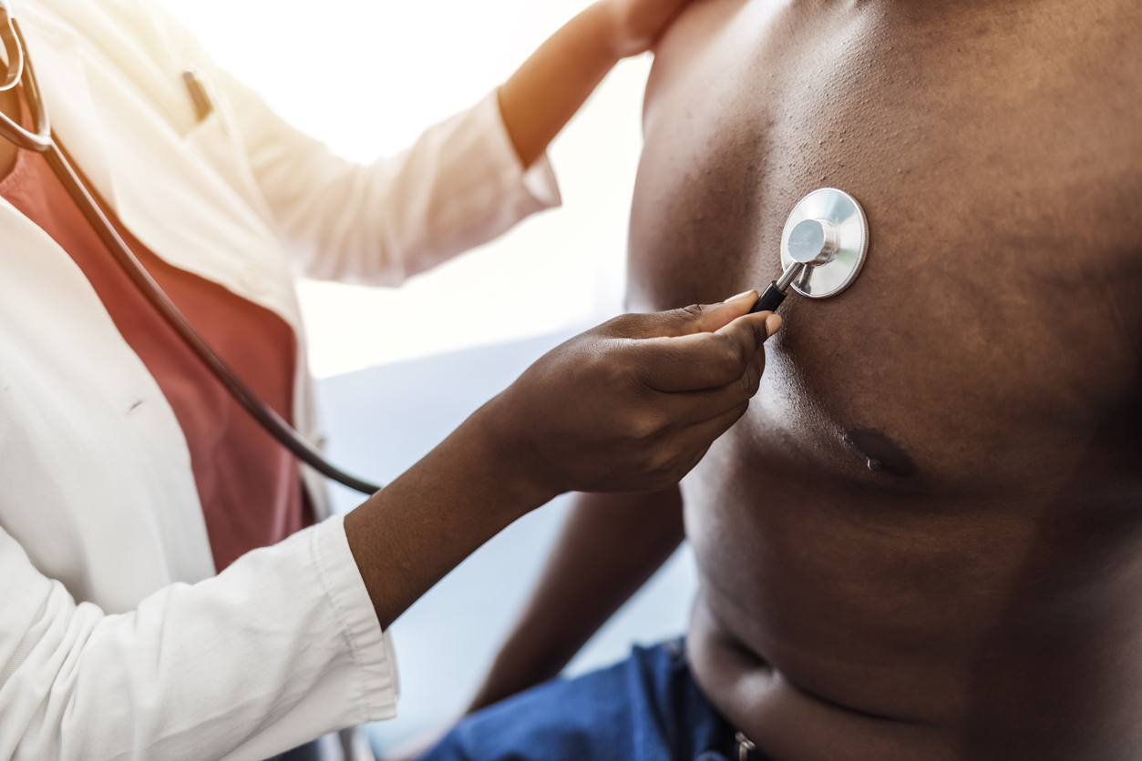 Young woman doctor holding stethoscope examining patient