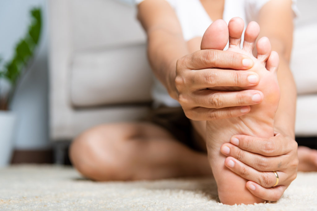 Woman clutching her foot in pain