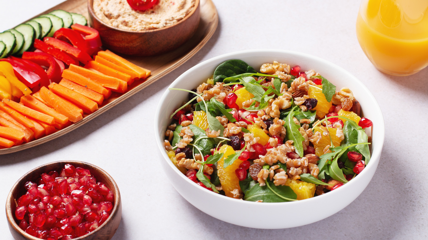 Colorful vegetarian or veganuary plates on table, view from above, top view. Healthy diet or lifestyle concept with green, healthy salads and hummus.